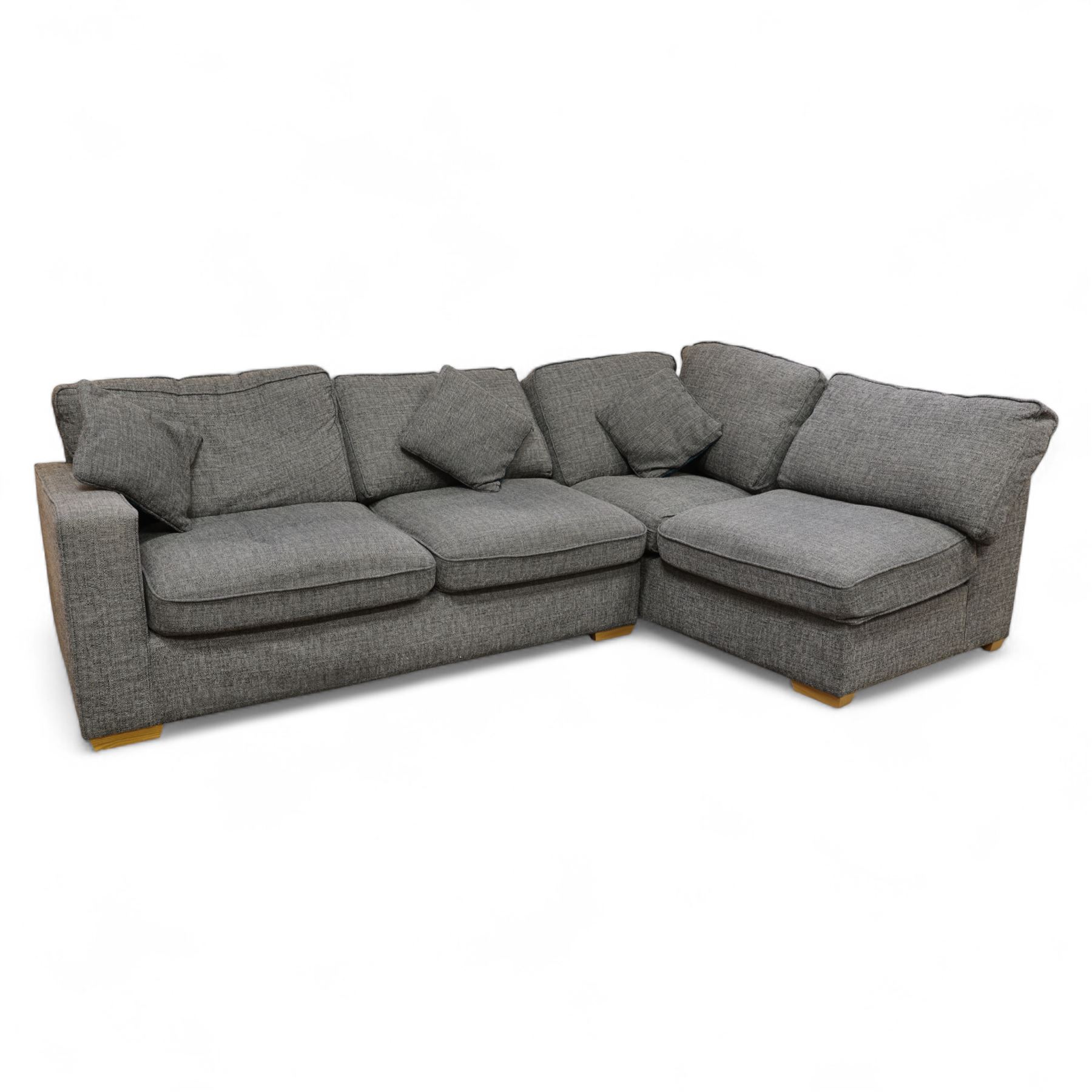Contemporary grey fabric corner sofa and ottoman, comprising modular sections with removable back and seat cushions, raised on light wood block feet