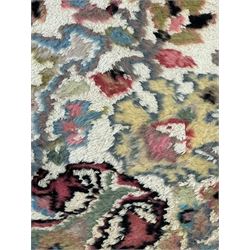 Persian design ivory ground rug, overall floral design with shaped central medallion, the main border decorated with trailing flower head pattern, within guard stipes 