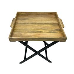 Light wood butlers tray on black painted folding stand 

