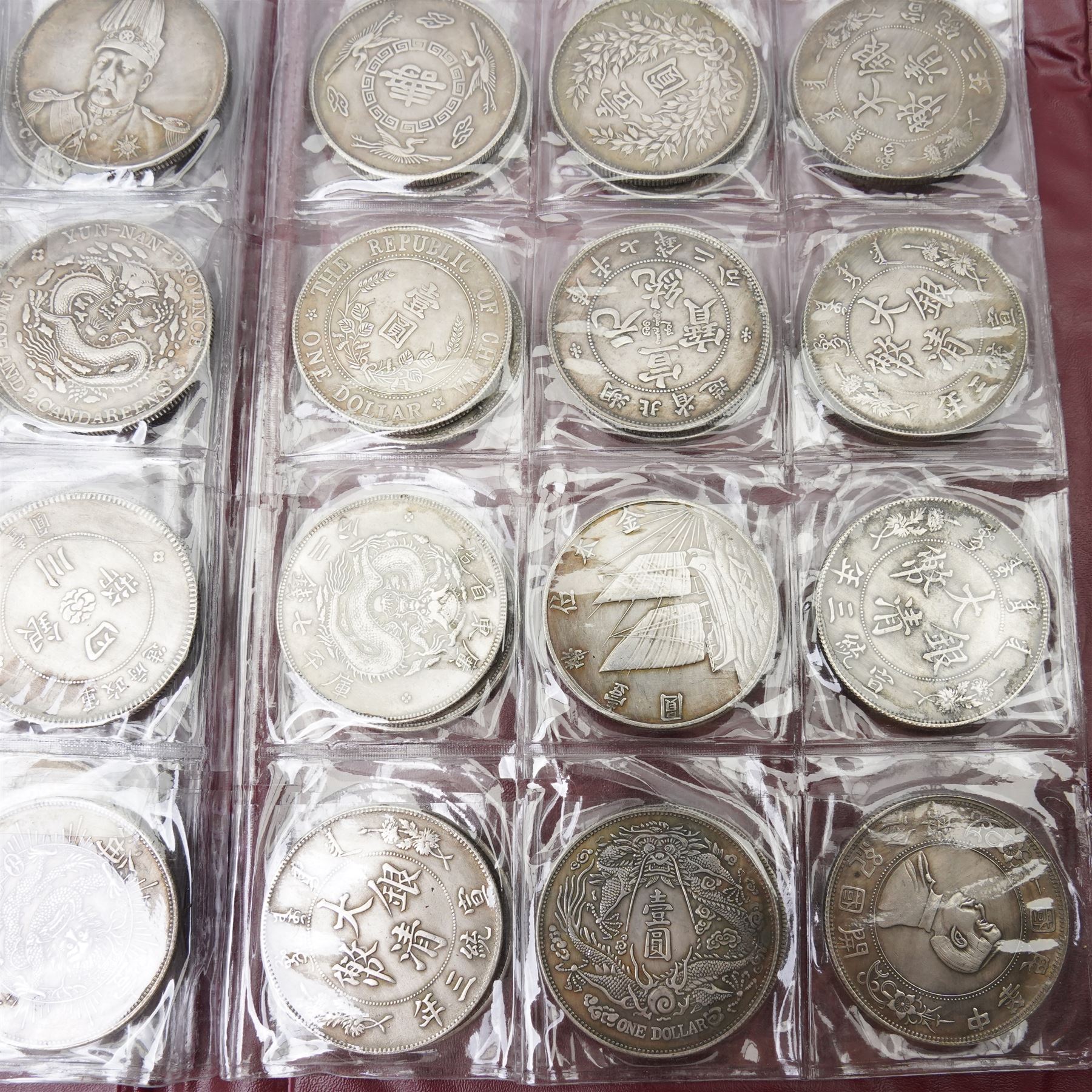 Folder containing various Chinese coins 