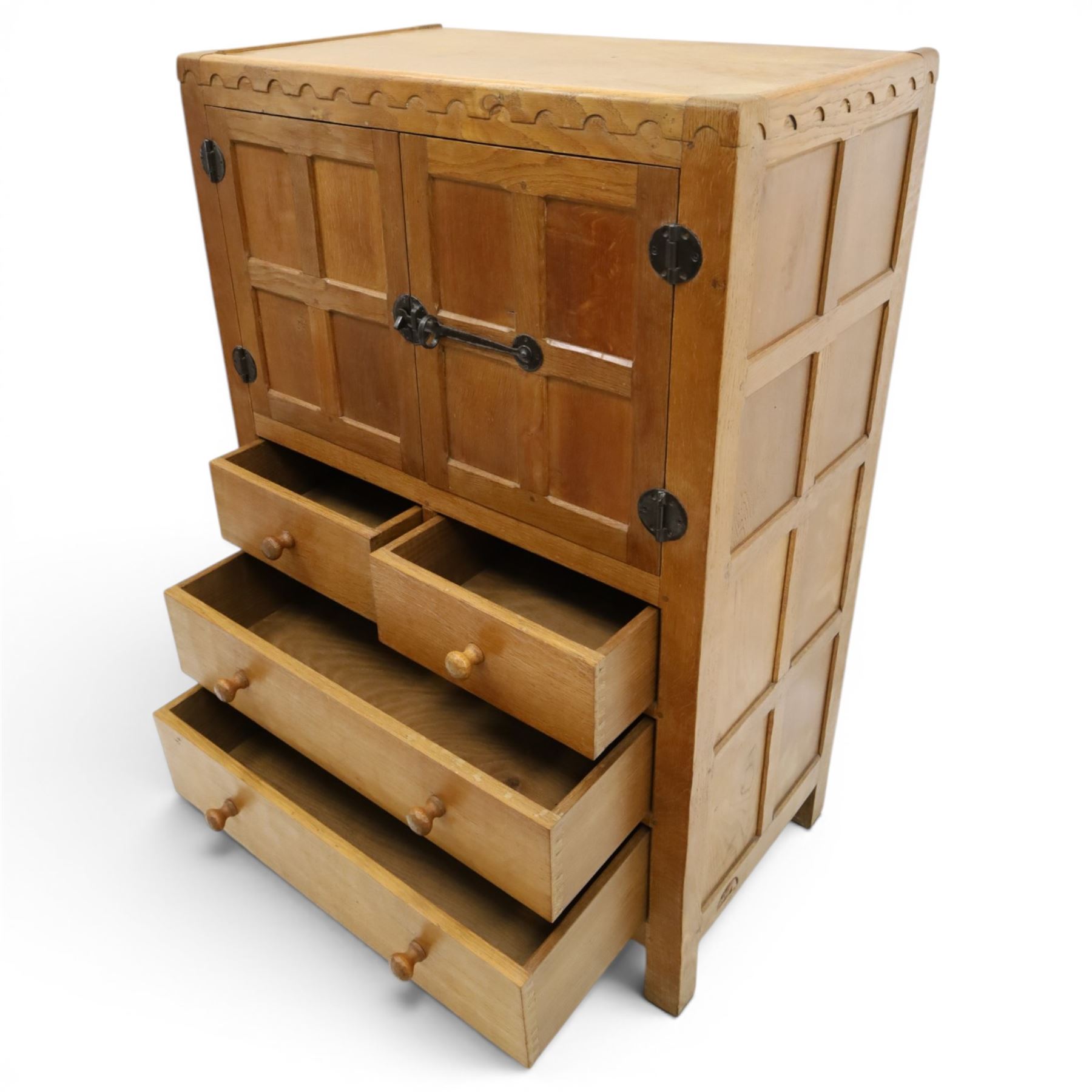 Mouseman - mid-20th century adzed and panelled oak tallboy chest, arcade carved cresting rail over two panelled cupboard doors with wrought iron fittings and latch, enclosing single shelf, over two short and two long drawers with lightly adzed facias and turned knob handles, raised on square supports, relief carved mouse signature, by the workshop of Robert Thompson of Kilburn