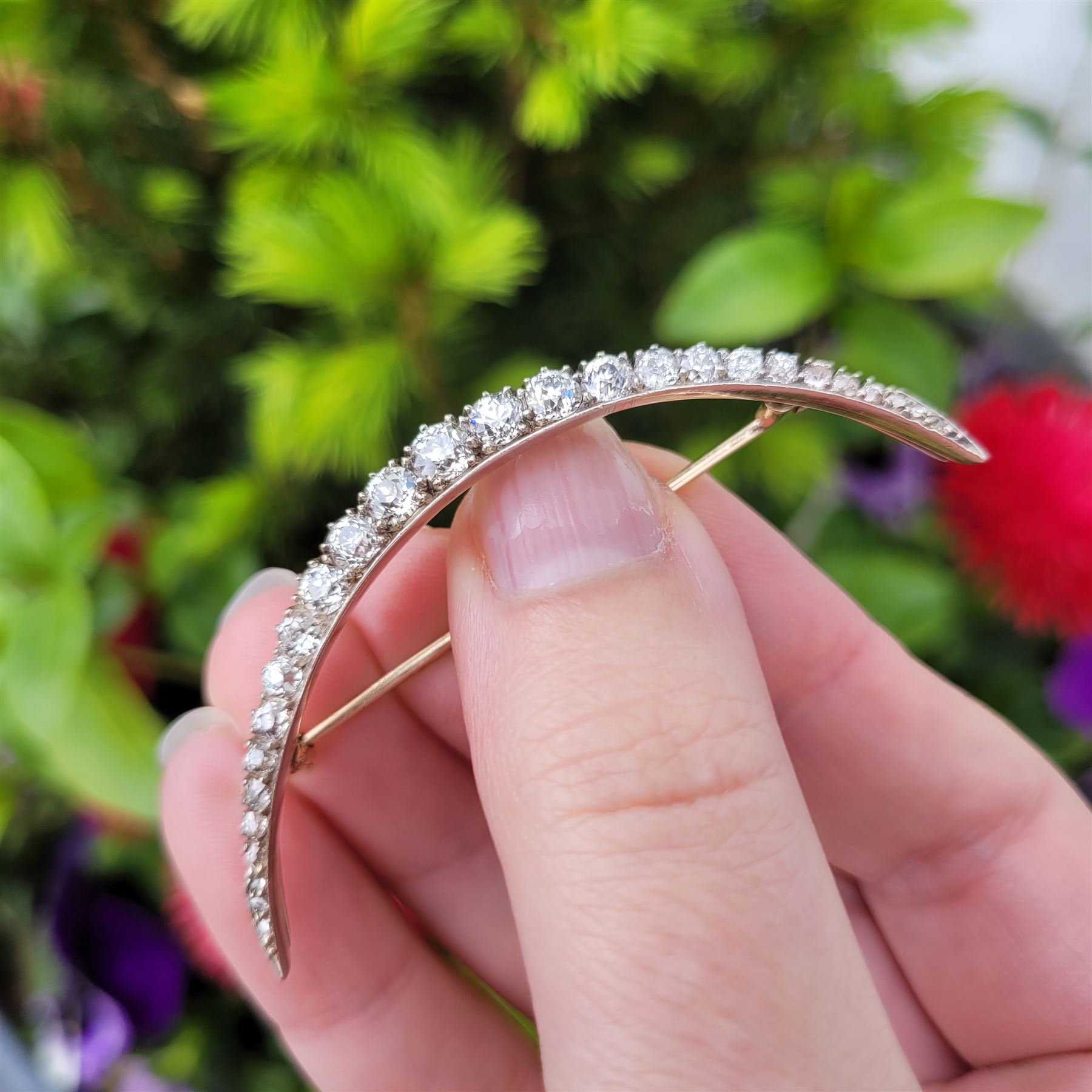 19th century silver and gold diamond crescent moon brooch, set with twenty-one graduating old cut diamonds and six rose cut diamonds, total diamond weight approx 2.00 carat