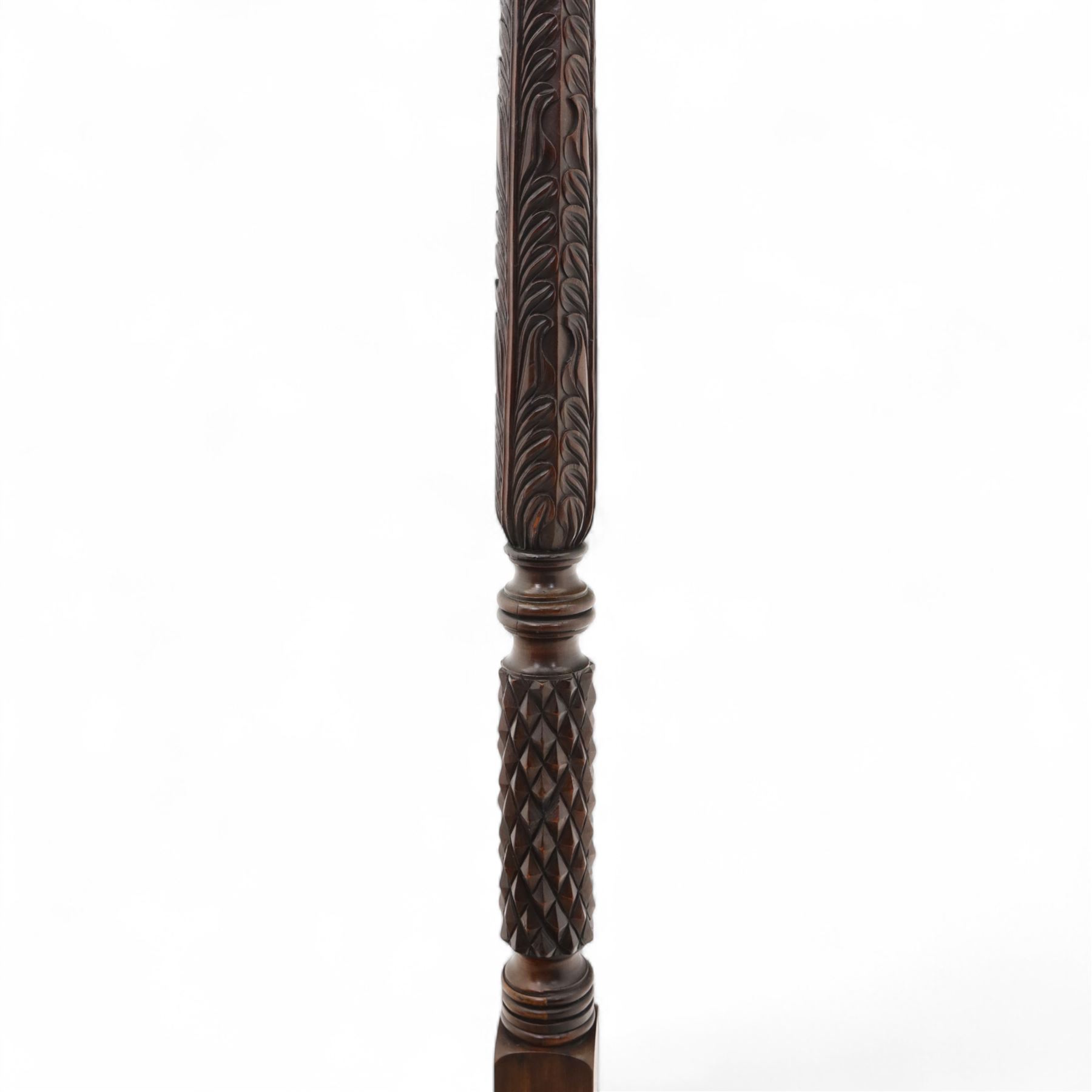 Late 20th century carved mahogany torchère stand, dished top above heavily carved column, with turned elements on moulded square base upon bun feet