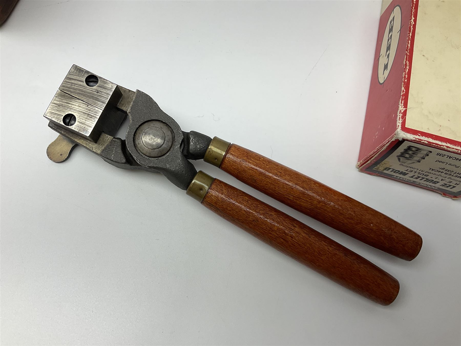 Three modern bullet moulds comprising Lee double cavity .44 calibre, boxed with instructions; and two Lyman .38 calibre; all in unrelated 19th century mahogany box