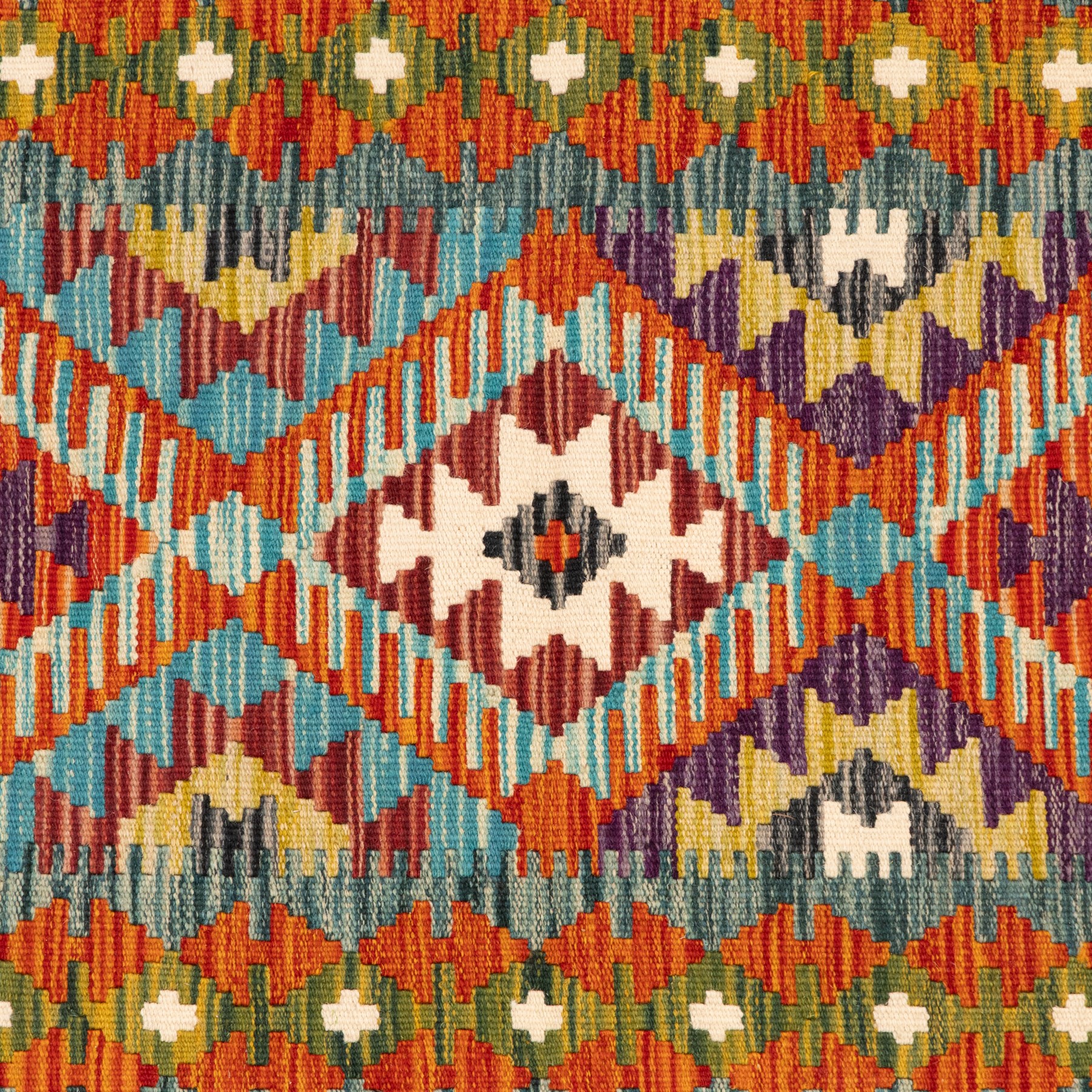 Afghan kilim amber ground runner rug, decorated a central column of repeating lozenge designs in multicolours with concentric geometric motifs, enclosed by an amber guard band with repeating diamond design