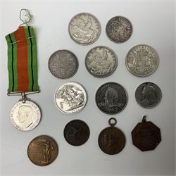 Victorian and later coins, to include Queen Victoria 1889 double florin coin, King George V 1918 half crown, two King George V crowns dated 1935 and a King George VI 1937 crown etc, together with a Defence Medal and two Society of Miniature Rifle Club medals 