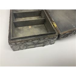 Liberty & Co Tudric pewter cigarette box, of plain rectangular form, with planished decoration to the slightly domed cover, opening to reveal a softwood interior, stamped Made in England 01234 Tudric Solkets beneath, together with another cigarette box, with applied pewter panels repousse decorated throughout with flower heads and leaves, with compartmentalised softwood interior, largest H5.5cm, W23cm