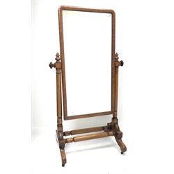 Victorian mahogany cheval dressing mirror, rectangular plain glass plate in cushion moulded surround, turned supports with finials on platform with out splayed feet, joined by double turned stretcher
