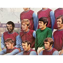 1970-1 photograph of West Ham United FC squad members, including Bobby Moore, Geoff Hurst, Harry Redknapp, Trevor Brooking, Jimmy Greaves, Billy Bonds etc, most players with signatures, 30 x 45cm, framed and glazed