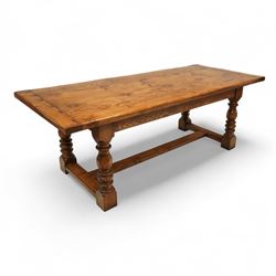 17th century design rustic oak refectory dining table, rectangular plank top over plain frieze rails, raised on heavily turned legs united by an H-stretcher  