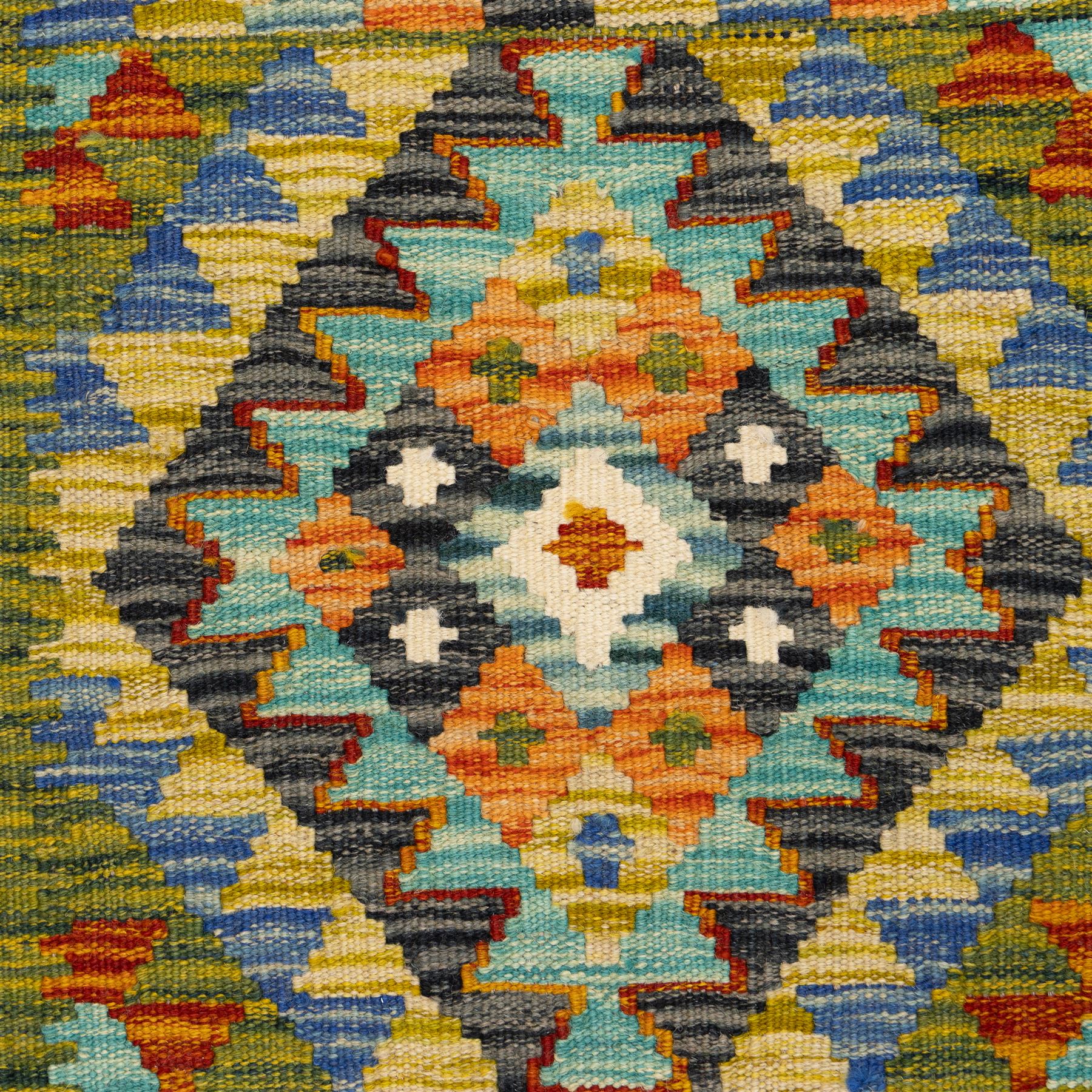 Two Chobi flatweave kilim runners with a repeating stepped diamond medallion design in live green, rust, teal, purple, and ivory, framed by chevron and geometric borders, (2)