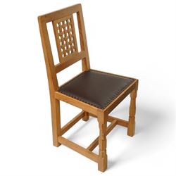 Mouseman - set of six oak dining chairs, pierced and carved lattice back over leather upholstered seat, on octagonal front supports united by stretchers, carved with mouse signature, by the workshop of Robert Thompson, Kilburn 