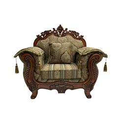 Italian Baroque design armchair, hardwood framed, the cresting rail carved and pierced with c-scrolls and flower heads, scrolled arms, upholstered in floral patterned and striped fabric, with scatter cushions 
