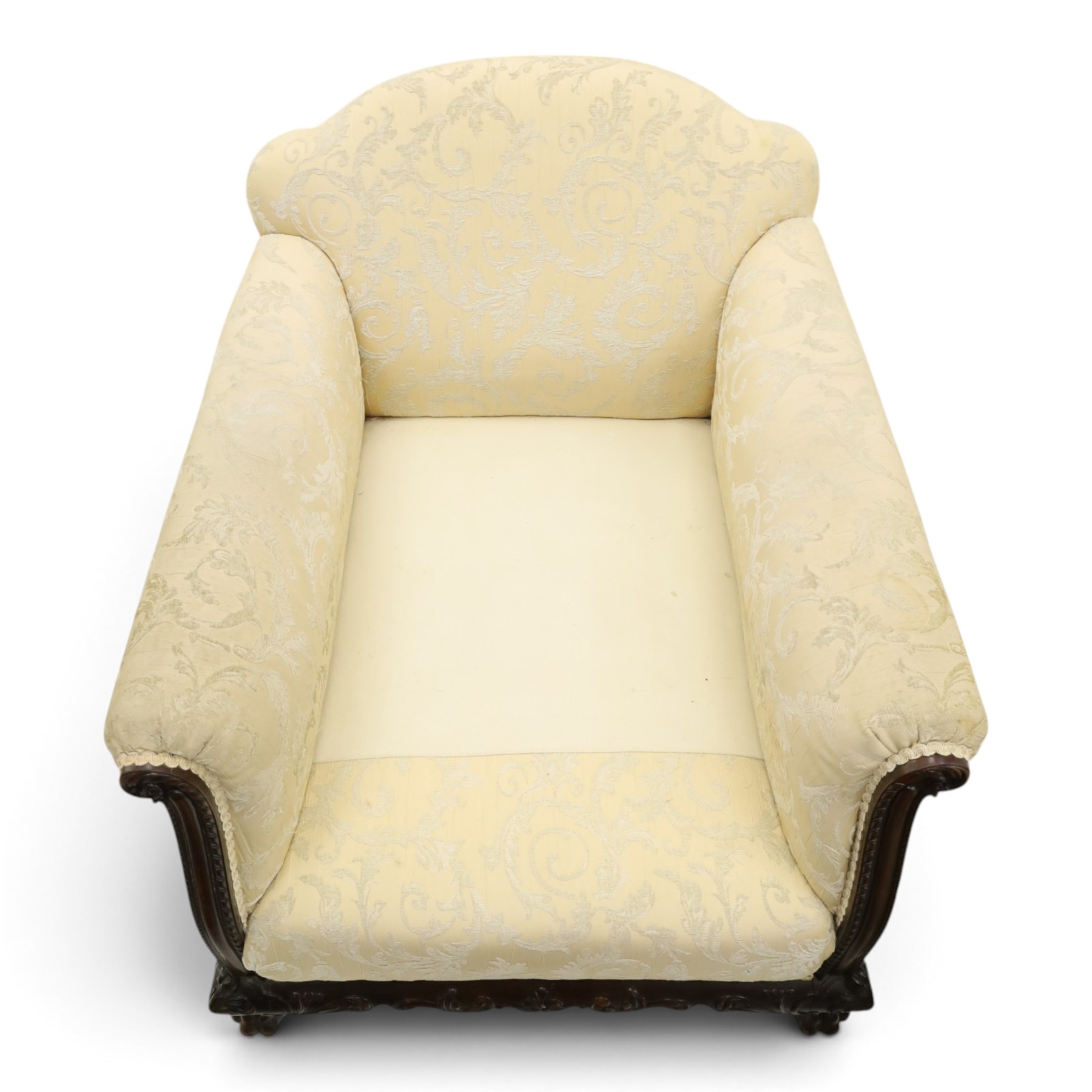 Quality Edwardian carved mahogany lounge suite comprising three-seater settee and pair of armchairs, the sofa with arched back over rolled arms and deep sprung seat, the arm terminals carved with acanthus rosette over gadroon and rope-twist moulding, the shaped apron carved and moulded with scrolling foliate acanthus motifs, terminating to four large front hairy paw and ball feet, upholstered in pale yellow foliate fabric with matching seat and scatter cushions (W200cm D105cm H73cm); the matching deep armchairs (W78cm D95cm H75cm)
