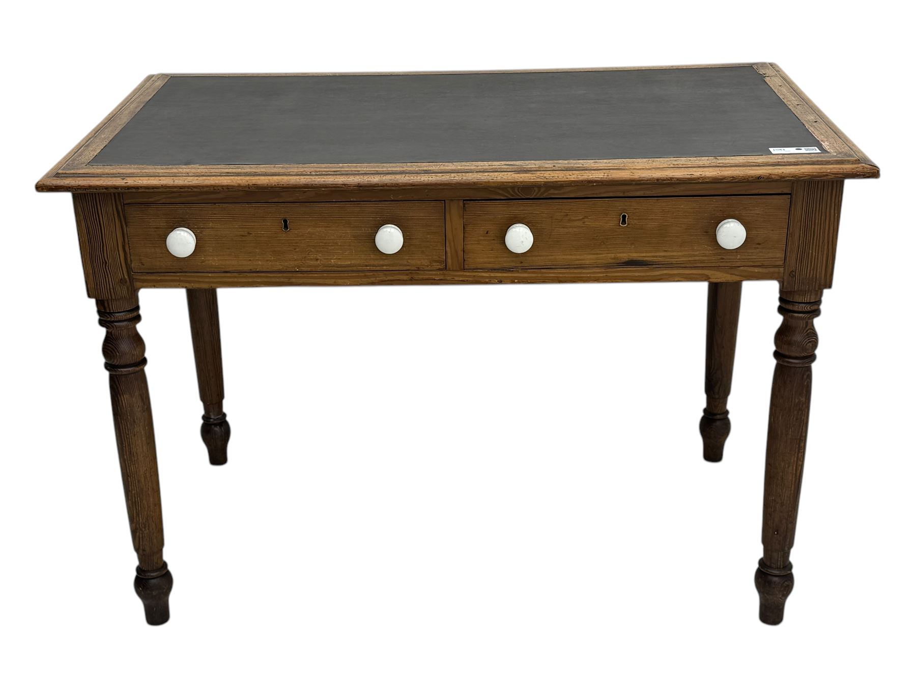 Victorian pine writing table, rectangular top with moulded edge and inset leather writing surface, the frieze fitted with two short drawers, raised by turned supports 