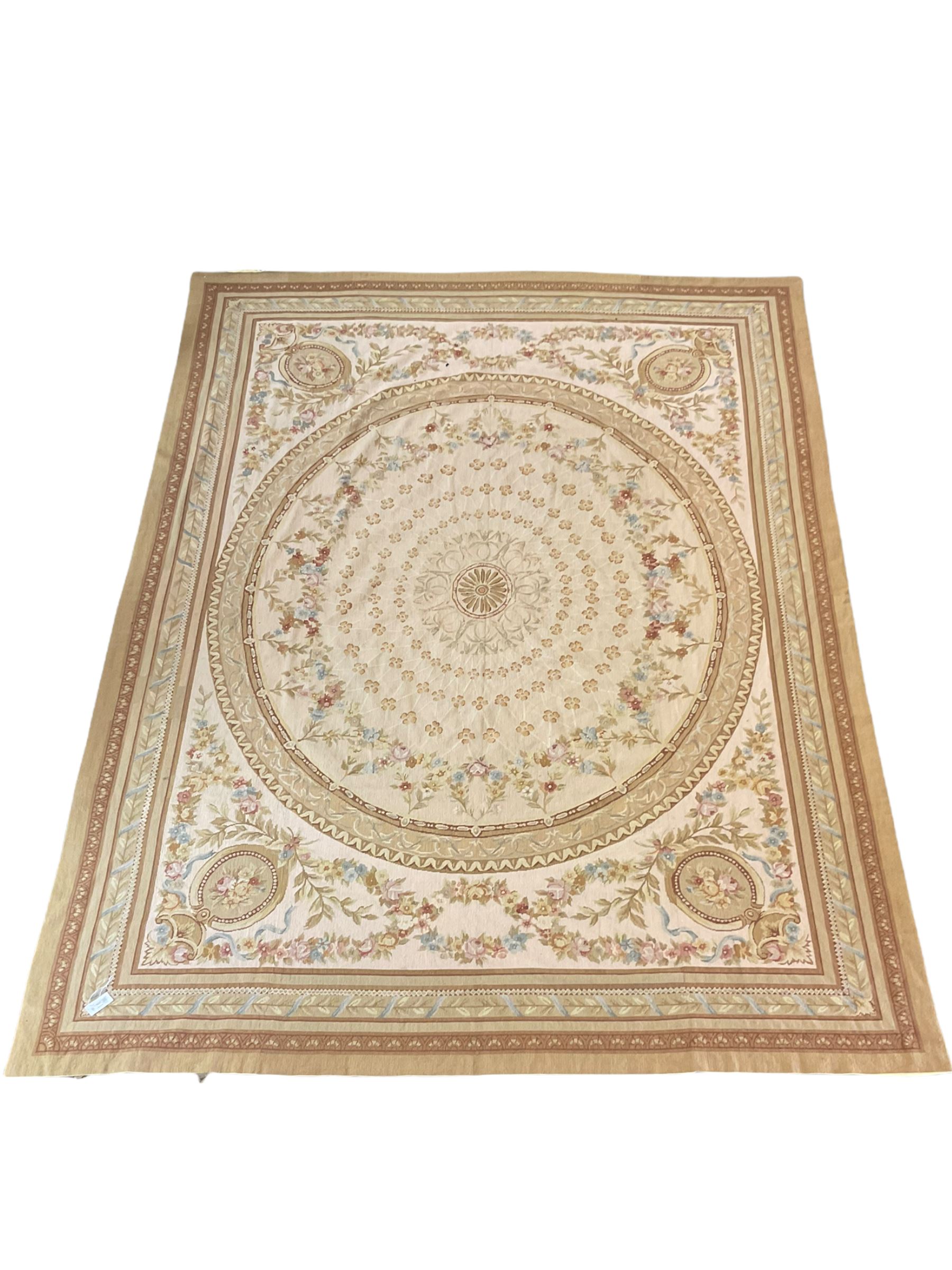 Late 20th century French style needle work Aubusson rug, circular field decorated with floral garlands and flower head motifs, multi-band border