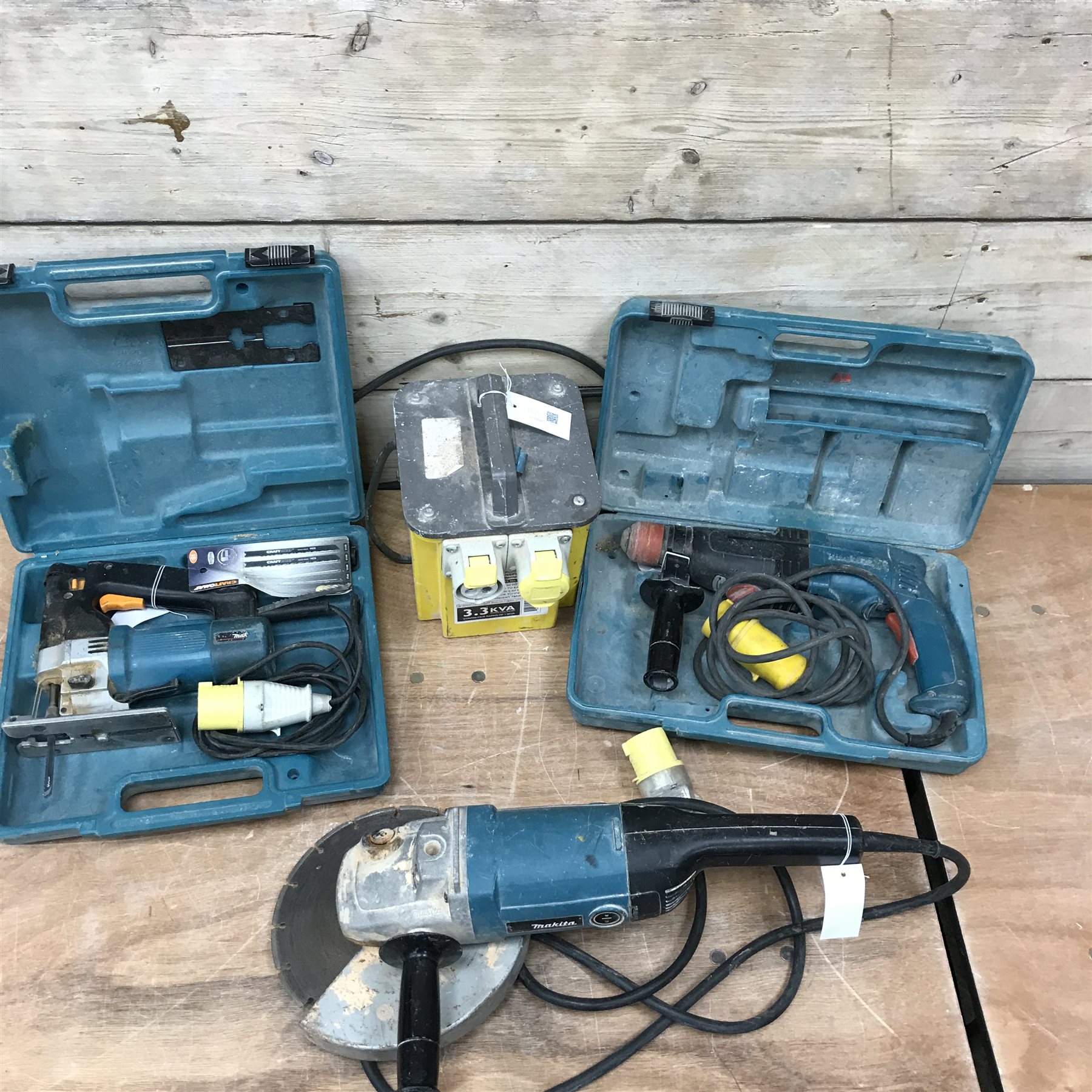 Makita 9069 9' 110V grinder, Makita HR2410 110V SDS drill, a Mikita 4304T 110V jigsaw and a 110v transformer