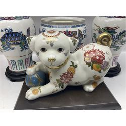 Franklin Mint Chinese style ceramics, comprising two vases, puppy and a planter, all on wooden stands
