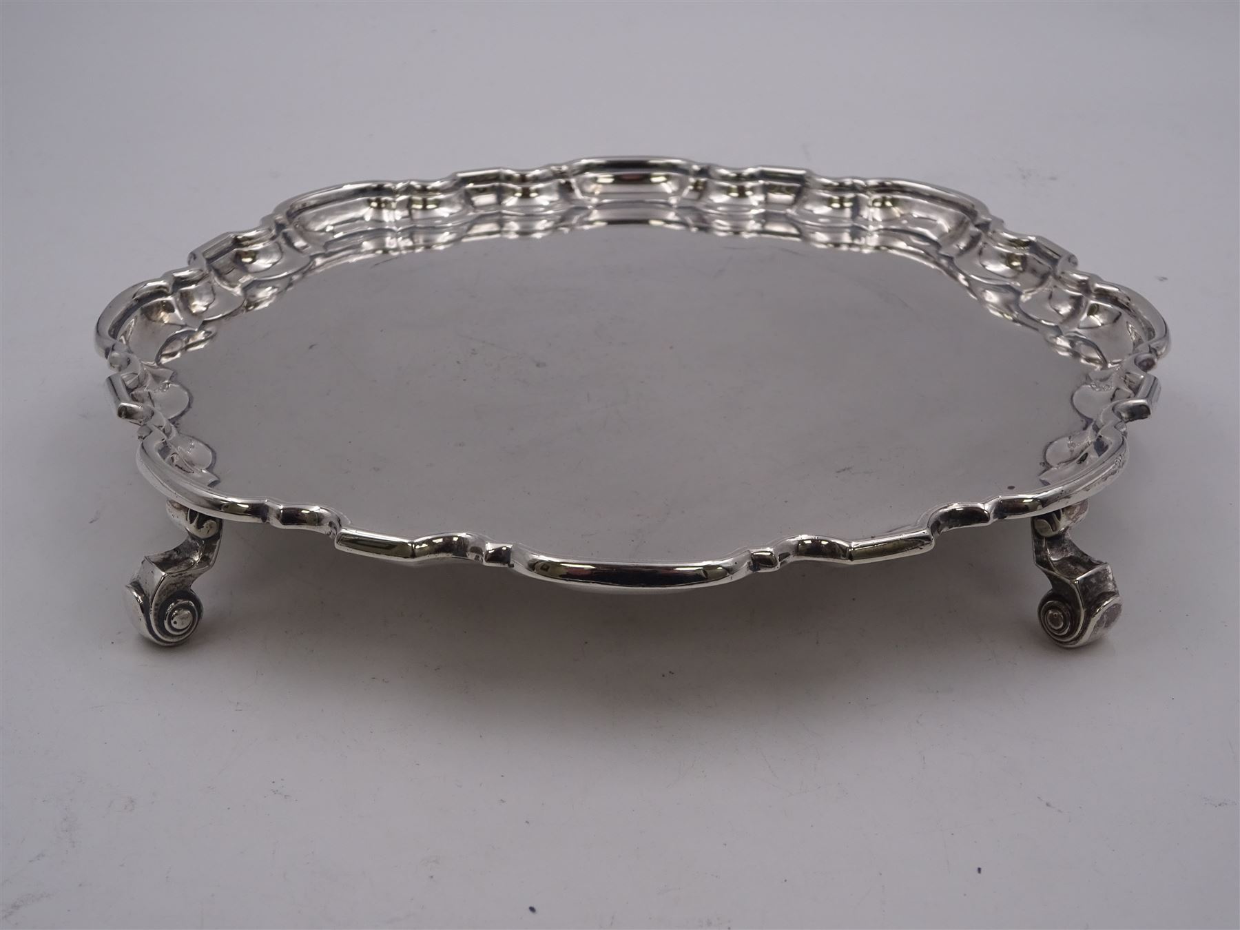 1930s silver waiter, of hexagonal form with pie crust rim, upon four scroll feet, hallmarked Manoah Rhodes & Sons Ltd, Sheffield 1936