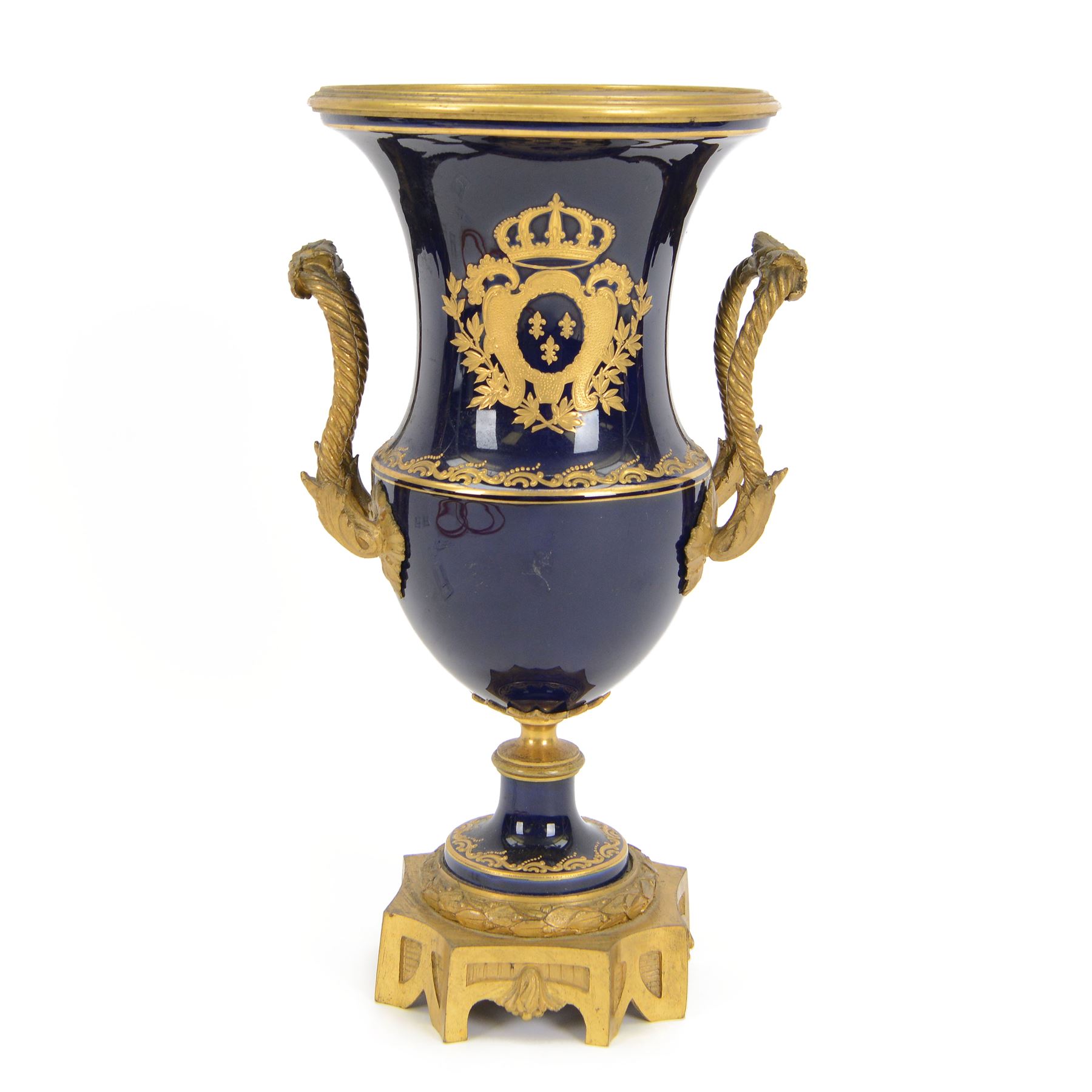 19th century Sevres style ormolu mounted porcelain twin handled urn, the body decorated with a gilt crowned crest of three fleur de lis against a cobalt ground, with spurious Sevres mark beneath, H26cm
