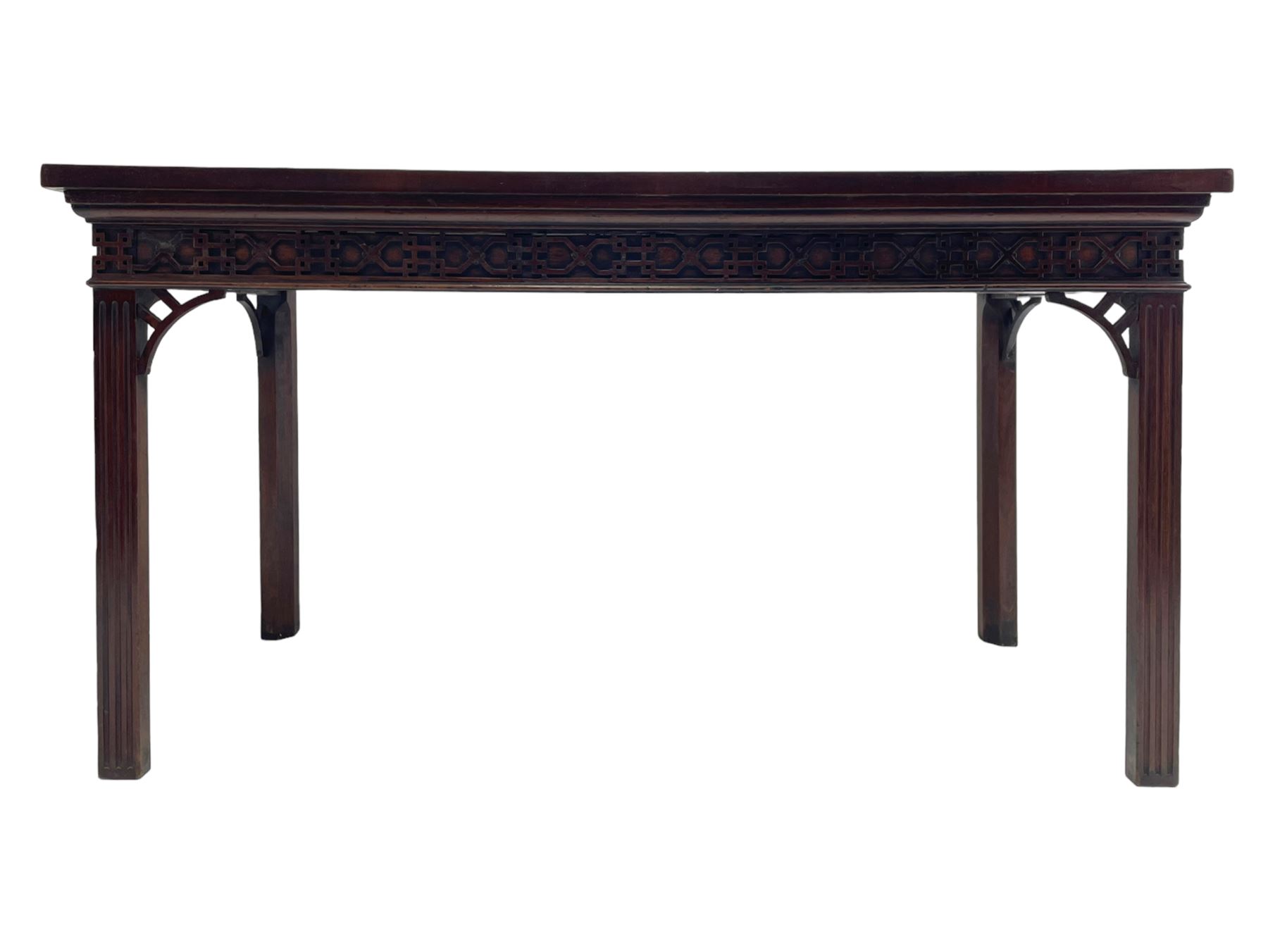 In the manner of Thomas Chippendale - early 19th century mahogany serving table, rectangular crossbanded top with boxwood stringing, the frieze with upper moulding over applied geometric fretwork, the left-hand side fitted with slide, on fluted square supports with inner chamfer 