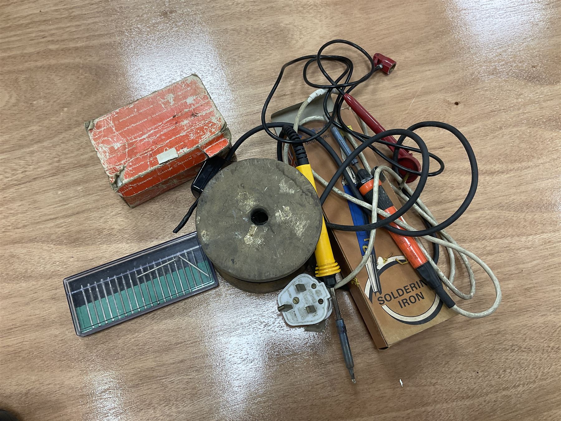 Six shelved cabinets for displaying ‘00’ gauge locomotives comprising plain plywood and white painted examples with track applied to various shelves, largest H63cm, W107cm, D27cm; Collection of tools for building model locomotives to include Weller PU-2D Soldering Pencil and Standard Tip Soldering Iron 20W/230V, Humbrol Modellers Airbrush, Power Supply Units and two wooden chests one of which housing a collection of tools including tweezers, scalping tools, wrenches etc 
