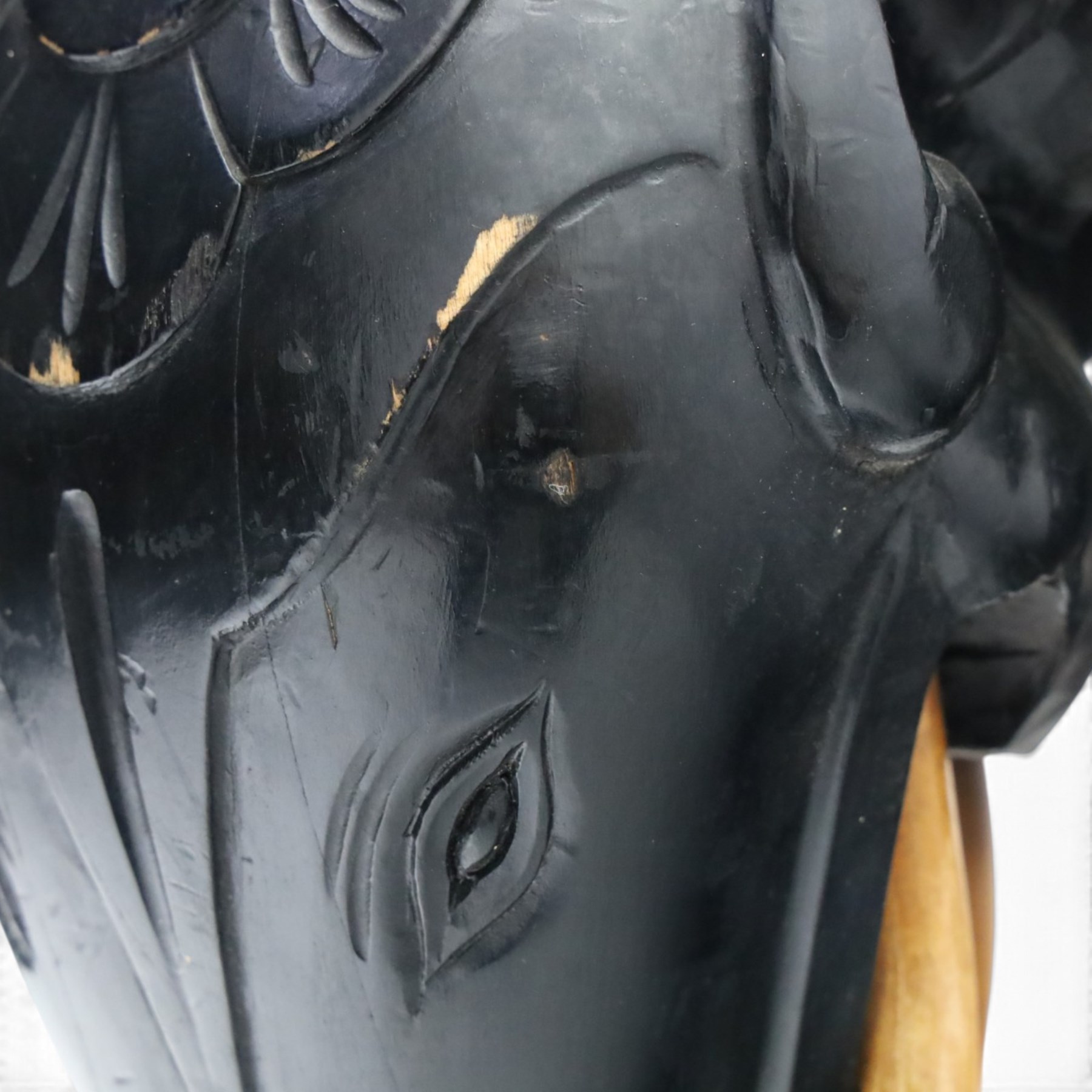 Elephant ebonised jardinière, moulded circular top raised on carved Elephant supports united by a shaped undertier