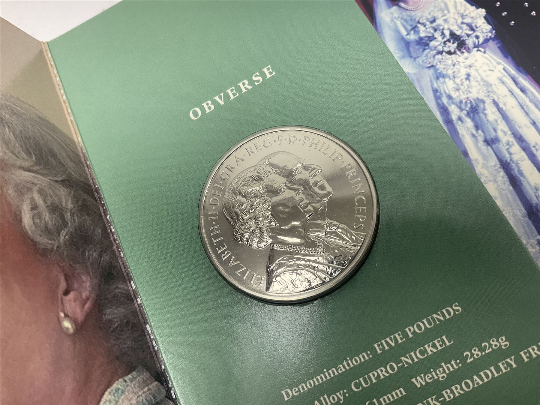 Eleven Queen Elizabeth II cupronickel five pound coins, in card folders or on cards