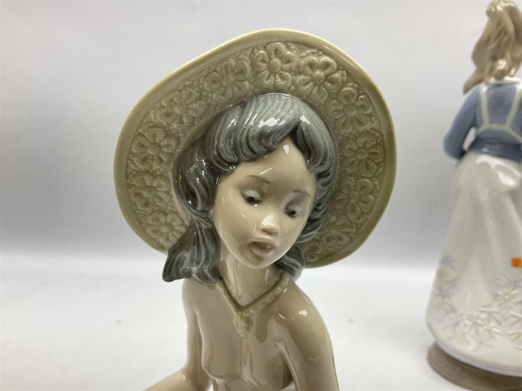 Three Lladro figures, comprising Modern Mother no 5873, Dropping the Flowers no 1285 and On the Beach no 1481, all with original boxes, largest example H30cm