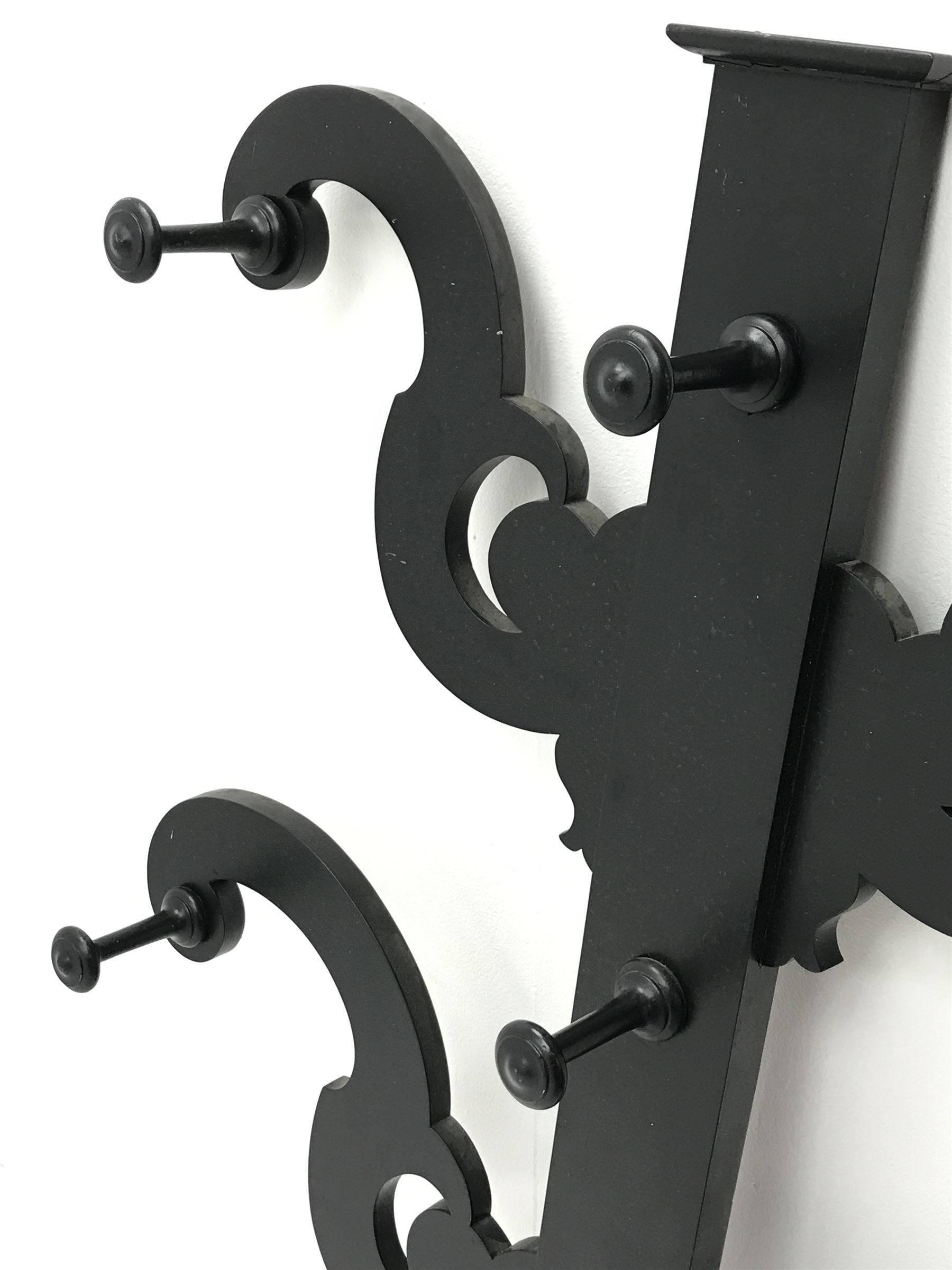 Victorian black painted mahogany coat stand, four shaped supports with