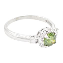 18ct white gold diamond cluster ring, the principal round brilliant cut fancy green diamond of approx 0.65 carat, surrounded by round brilliant cut white diamonds and diamond set shoulders, Birmingham 2007, total white diamond approx 0.20 carat