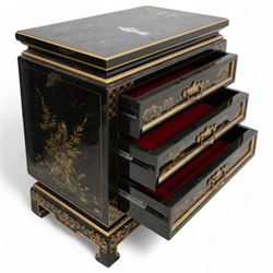 Chinese design black lacquered cupboard, decorated with birds and trailing flowers (W61cm, H81cm, D31cm); together with a similar Chinese design three drawer chest (W57cm, D34cm, H61cm)