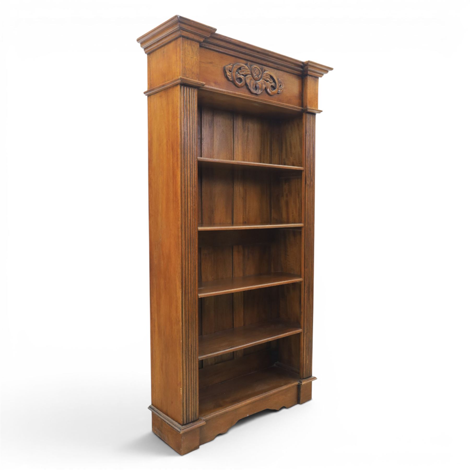 Hardwood open bookcase, fitted with five open shelves, applied carving to top facia