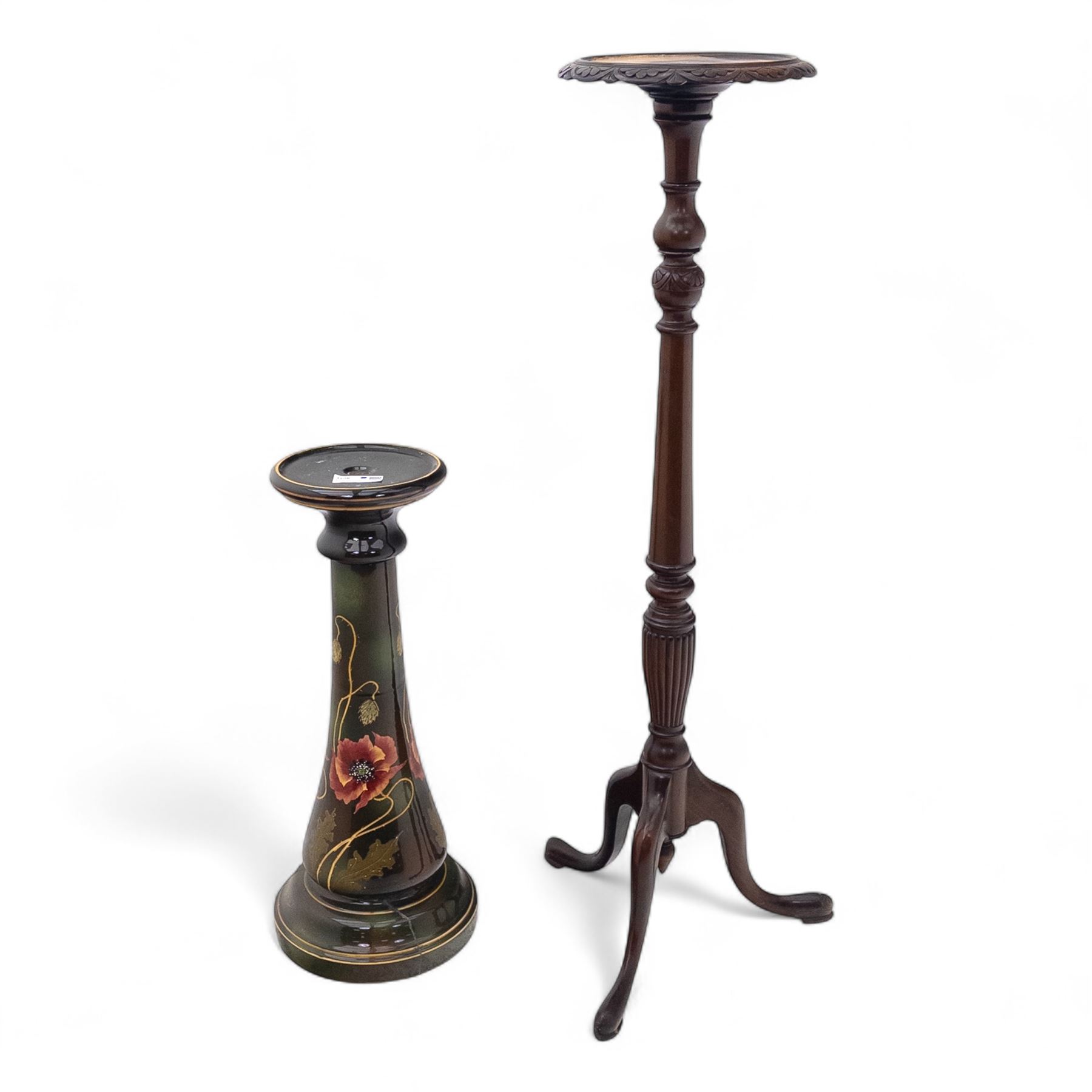 Early 20th century mahogany torchère and ceramic jardinière, circular dished top with carved leaf moulded edge, on ring turned and tapering column raised on tripod splayed supports, together with a hand-painted ceramic jardinière stand decorated with roses on a green ground (Torchère H 122cm, W 31cm, Jardinière H 71cm, W 30cm)