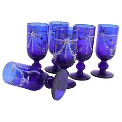19th century style blue glass decanter and six drinking glasses, the decanter of mallet form with lozenge shaped stopper, all with white enamel and gilt swag decoration, decanter H34cm, drinking glasses H11.5cm