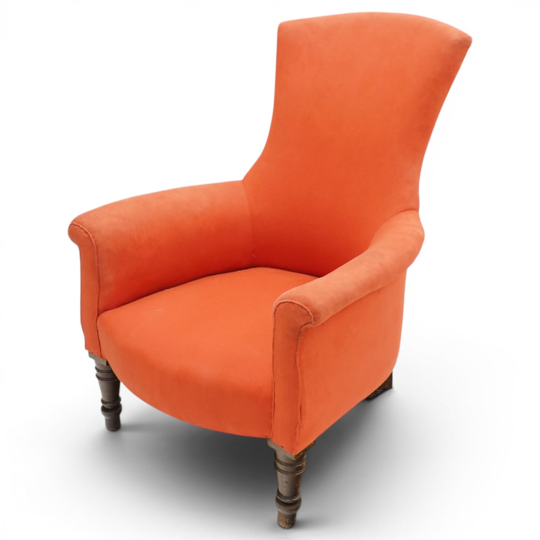 Victorian coral red upholstered armchair, the swept high back above padded arms with rolled fronts, on short turned ebonised front supports with castors