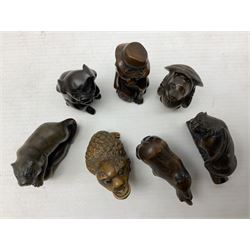 Seven netsuke, modelled as a tiger, pig, cat in a hat, rhino, mythical creature, bear in a hat and a tiger
