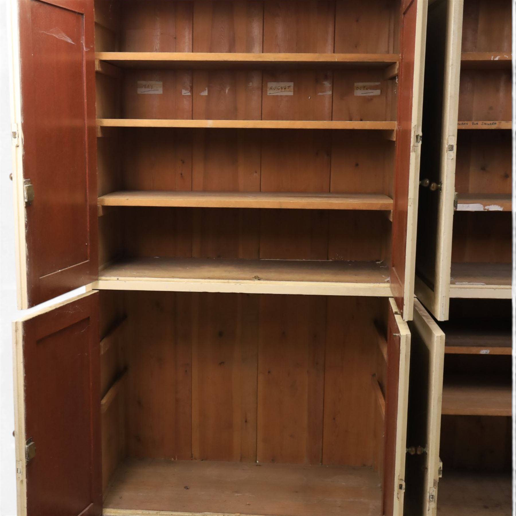 Large Georgian painted pine housekeepers cupboard, projecting cornice with four sets of twin cupboard doors with shelving enclosed