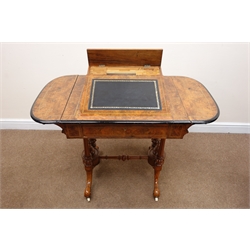  Victorian figured boxwood strung walnut fall leaf writing table, the inset leather slope top with hinged stationary compartment above a frieze drawer, the twin tapering supports with spire finials and turned stretcher on moulded cabriole legs with ceramic castors, W107cm, D57cm, H75cm   