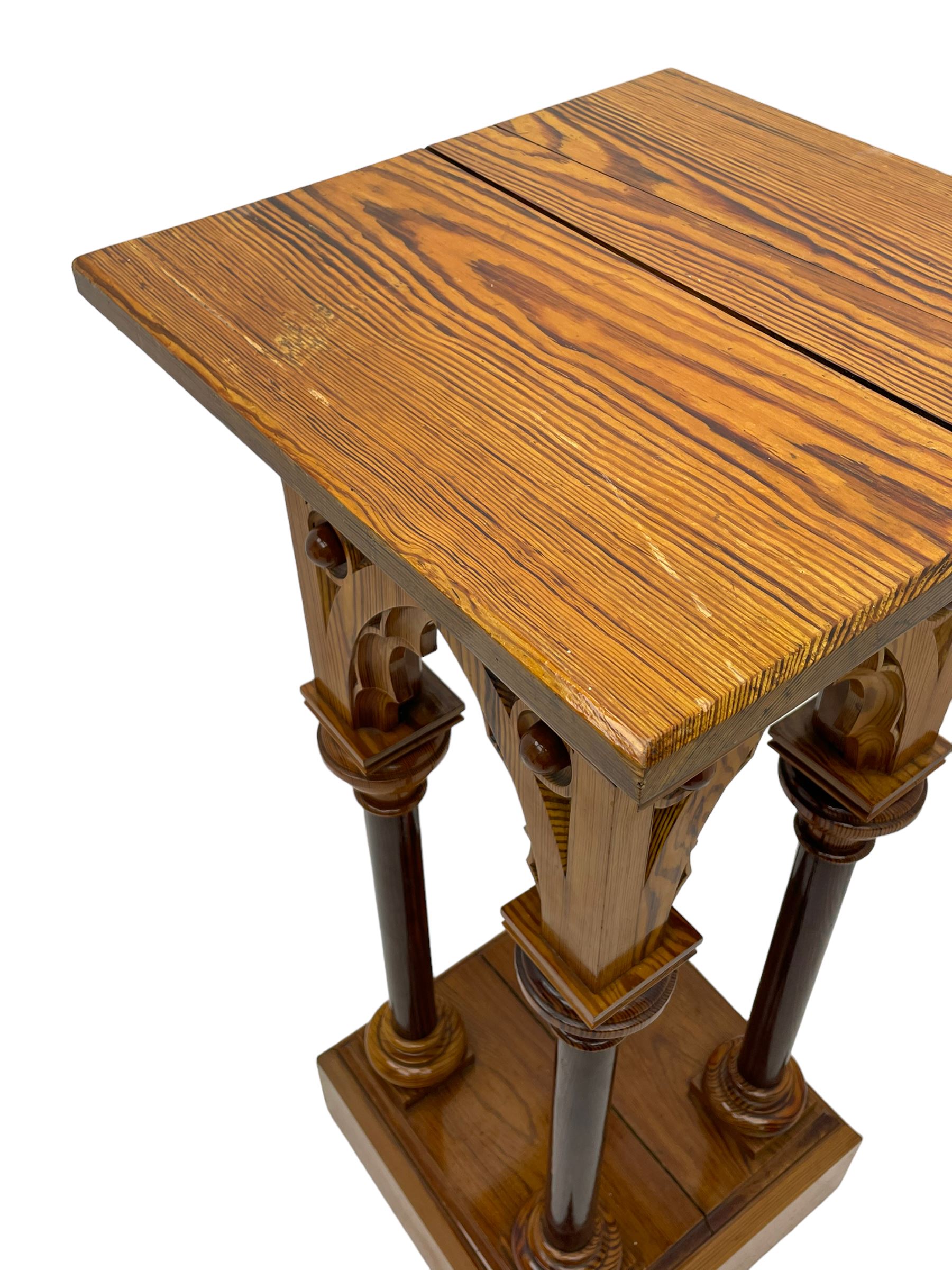 19th century pitch pine ecclesiastical pedestal stand, the square chamfered top over cusped Gothic pointed arches and four turned column supports, stepped and moulded plinth base