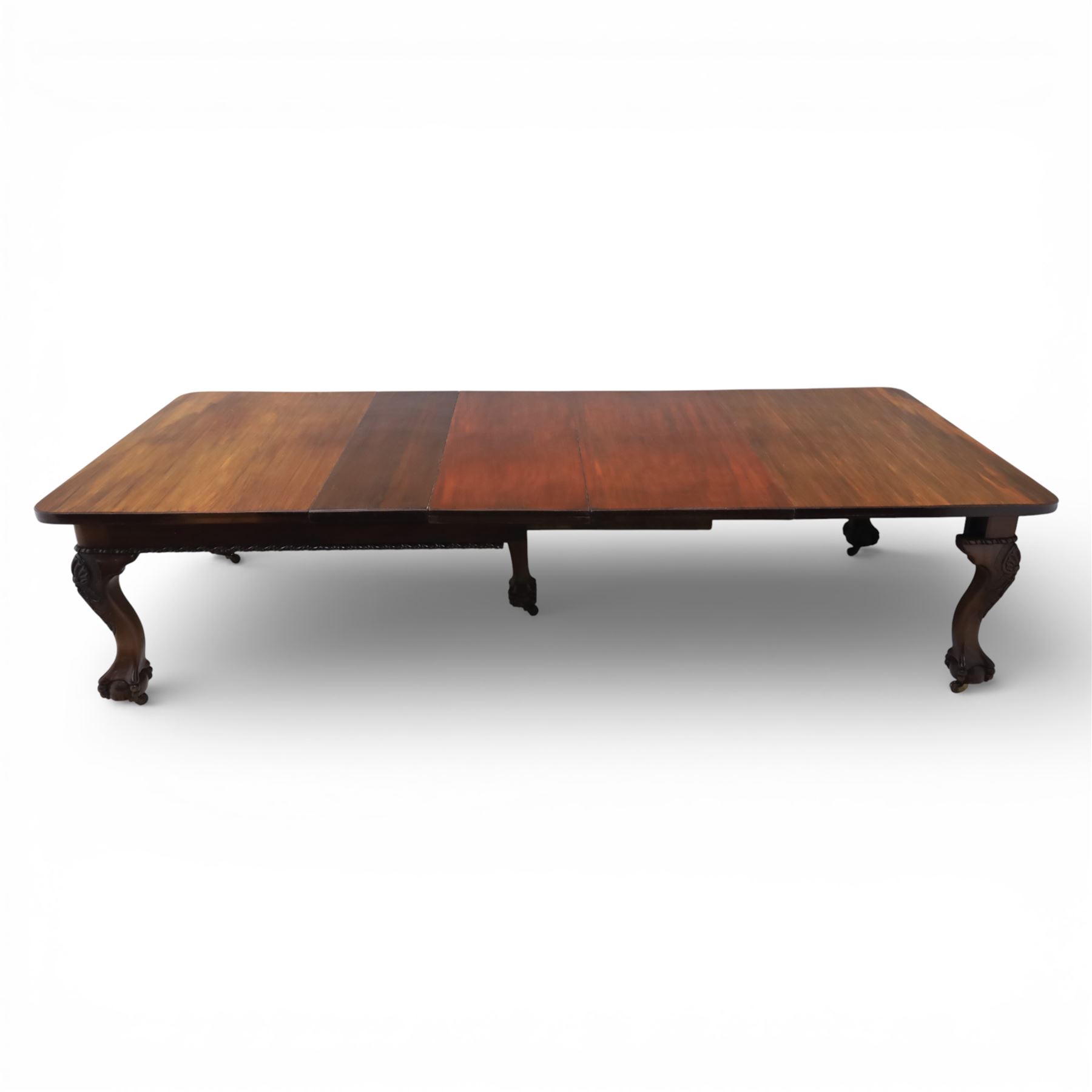 19th century mahogany extending dining table and eight chairs, rectangular top with rounded corners and additional leaves, plain frieze with carved gadrooned edge detail, raised on cabriole supports terminating in ball and claw feet, together with a set of eight mahogany dining chairs including two carvers, the chairs with curved top rails and pierced splats, upholstered drop-in seats, on turned supports

(Table extends to 312cm)