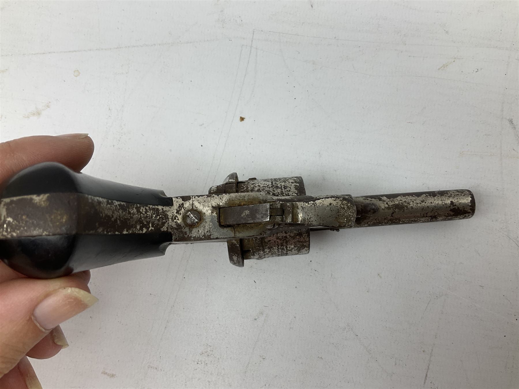 19th century 7mm six-shot pin-fire revolver, with folding trigger, two-piece ebonised grip and ejector rod in butt L17cm