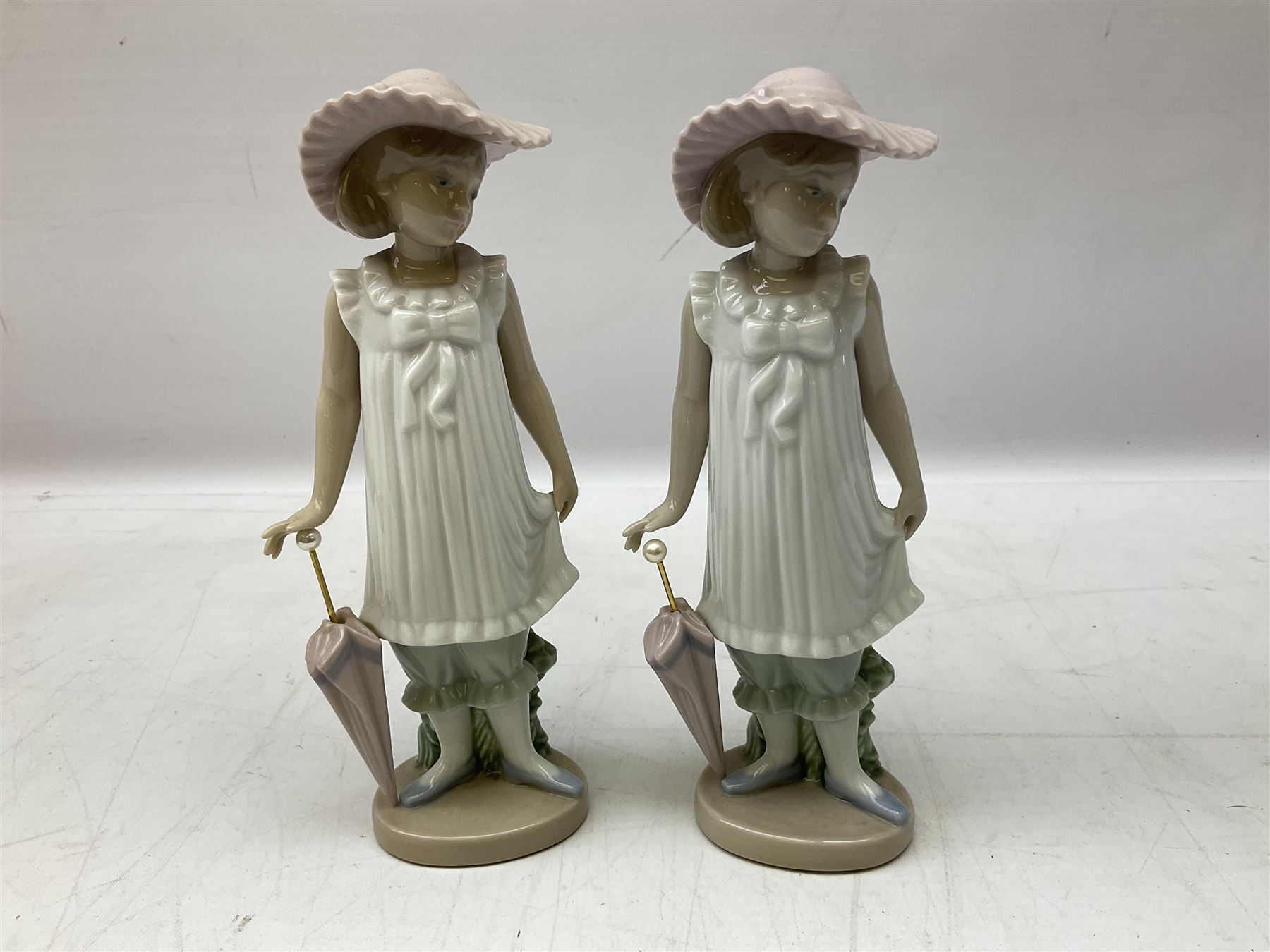 Quantity of figures to include Lladro example modelled as swan together with three Nao figures to include two April Showers no 1126, two with boxes 