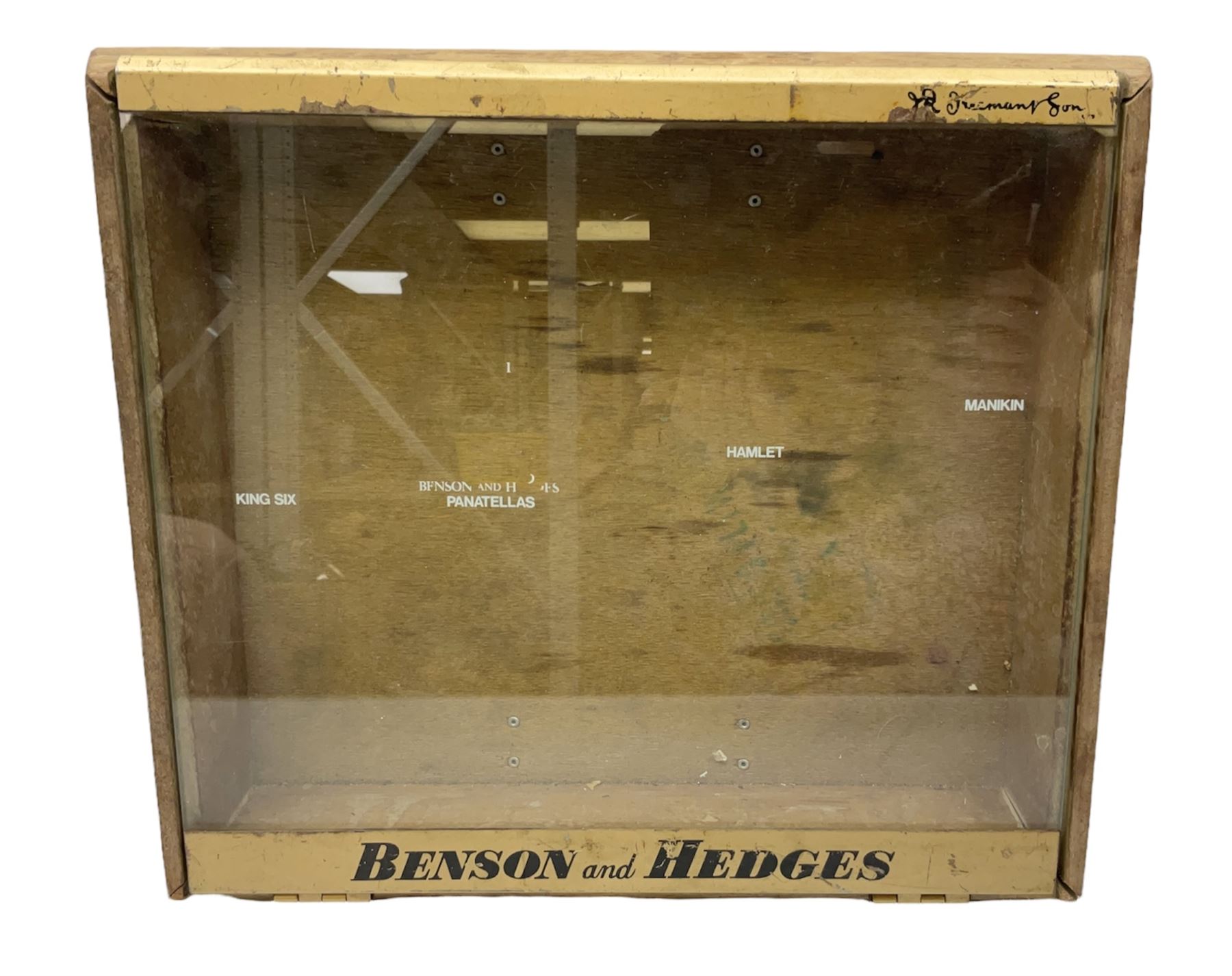 Benson and Hedges countertop glazed display cabinet, the glass hinged lid with white labelling of various cigarettes and cigars, the gilded metal bands with black lettering, W38cm D33cm H8cm