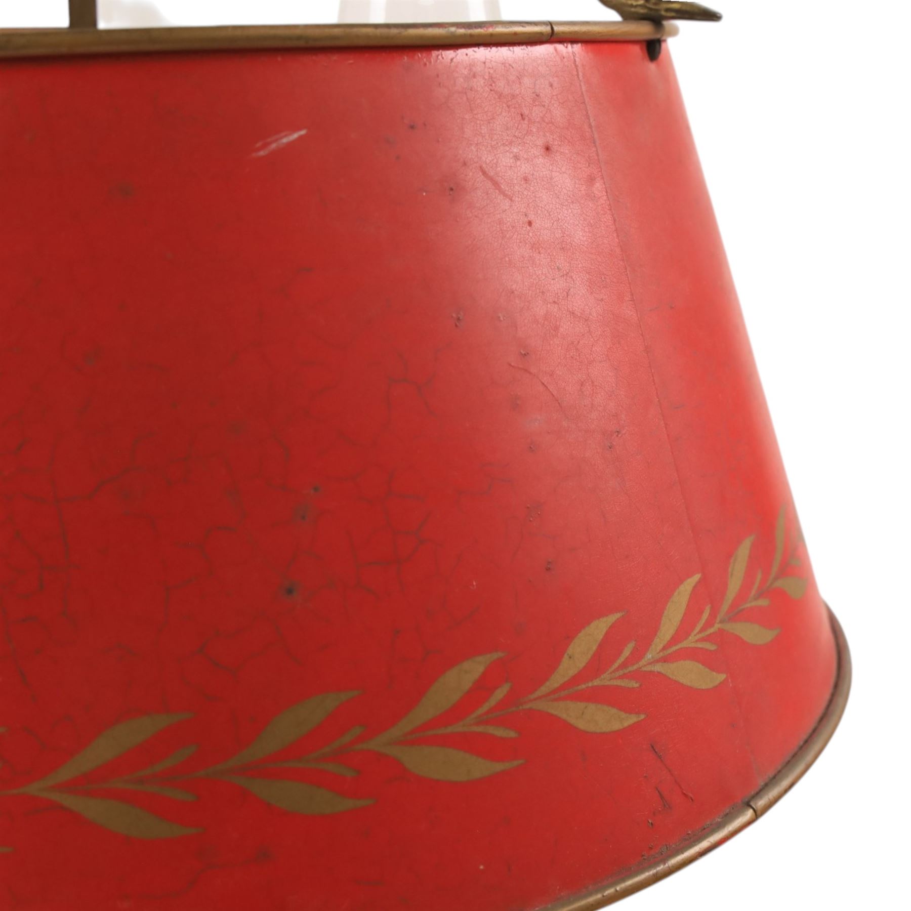 Bouillotte lamp, the adjustable red tole shade above three brass sconces upon a circular dished base, H54cm