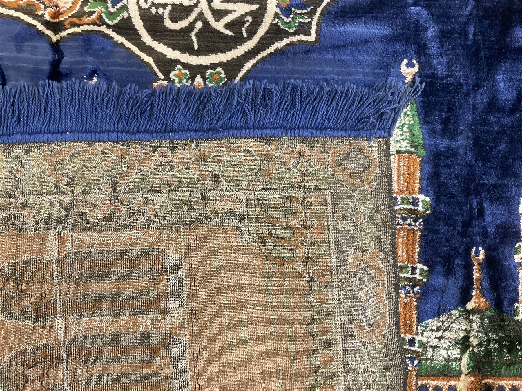 Indigo ground family prayer rug, depicting Masjid al-Haram in Mecca within floral design borders 