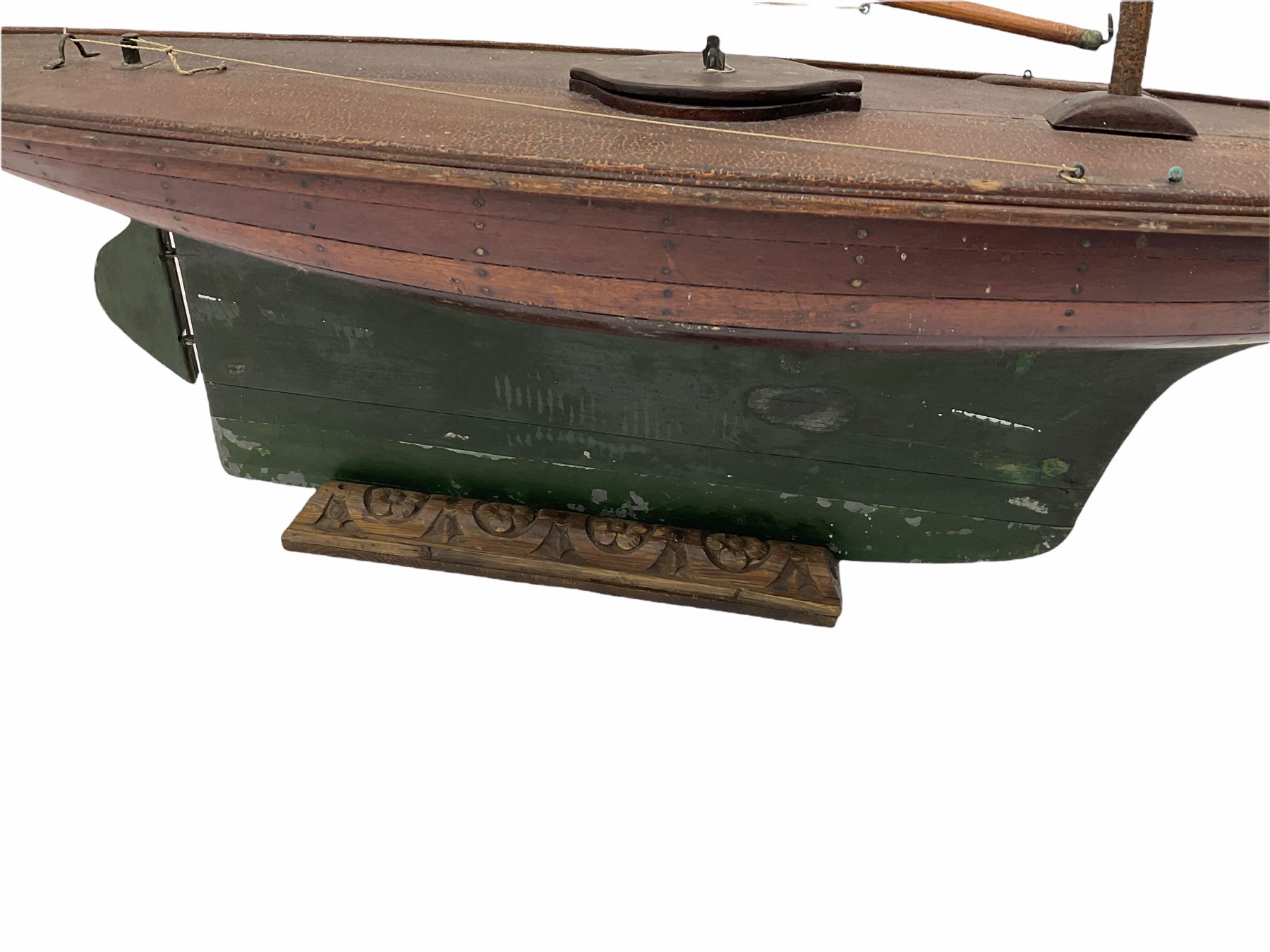 Large Victorian pond yacht, the planked hardwood hull with large lead weighted keel and working rudder, simulated planked deck and single mast with original sails; on later scratch-built wooden stand L117cm H151cm