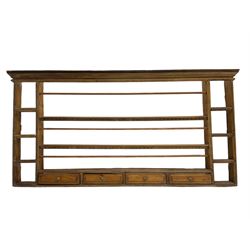 18th century pine wall hanging plate rack, projecting cornice over three tiers and four spice drawers, flanked by four tier shelves