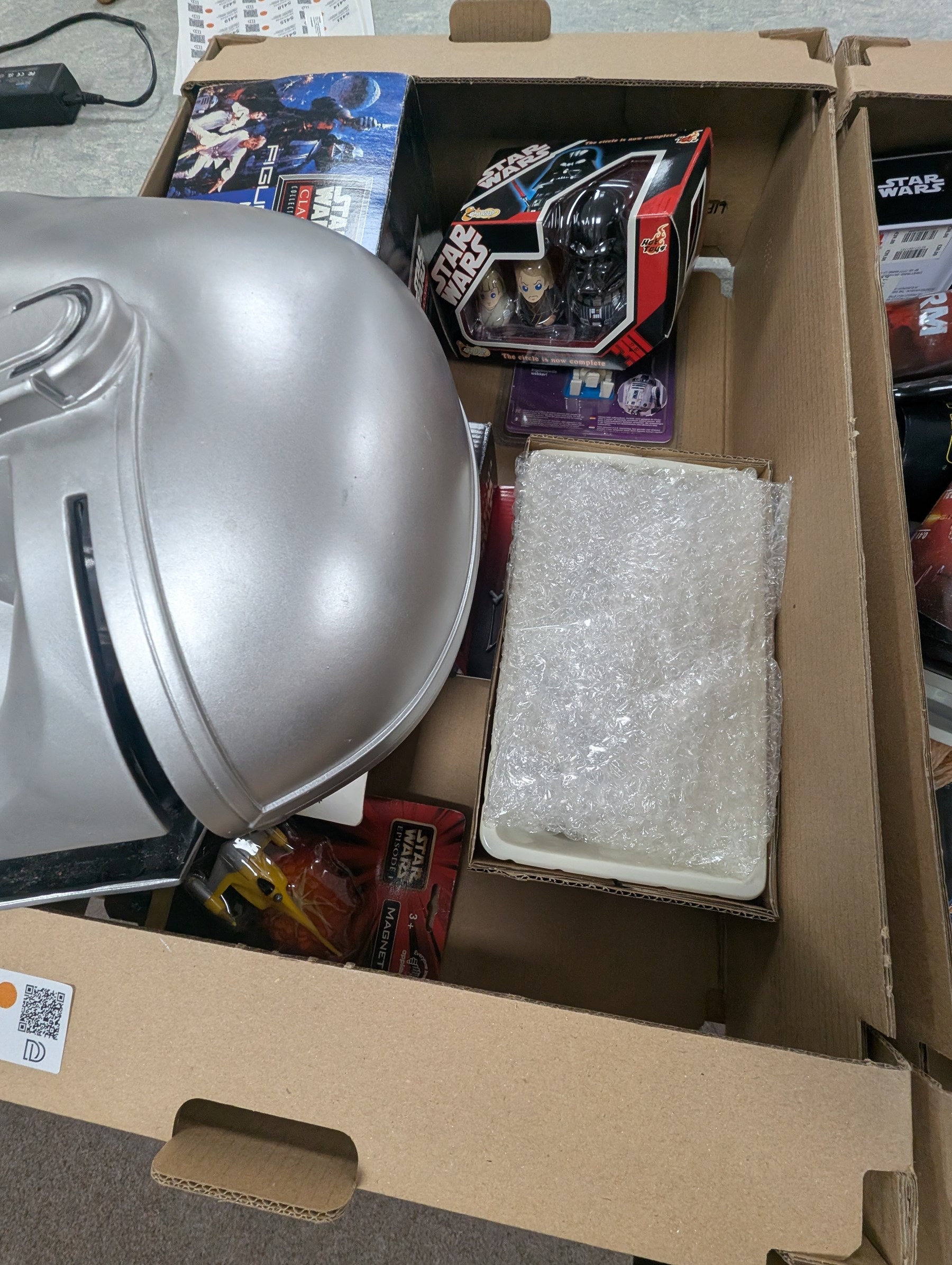 Star Wars collectables, including Mandalorian helmet, Topps foil caps, plastic cups, mug, figures, Masterworks Movie collection, Return of the Jedi Poster, magnets, watch, etc,in three boxes