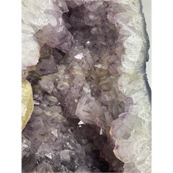 Amethyst crystal ‘cathedral’ geode, free standing with flat base and prepared outer surface, with well-defined crystals of various sizes within the cavern, H39, L32cm